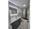 Updated bathroom with new vanity, lighted mirror, and step-in shower at 4619 Helena Ne St, St Petersburg, FL 33703
