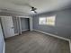 Bedroom with open closet, wood-look floors and a window at 4619 Helena Ne St, St Petersburg, FL 33703