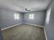 Neutral bedroom with modern fan, wood-look floors, and windows at 4619 Helena Ne St, St Petersburg, FL 33703