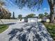 Charming single-story home with a paved driveway and well-maintained landscaping under a blue sky at 4619 Helena Ne St, St Petersburg, FL 33703