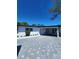 Charming single-story home featuring a white exterior, covered entry, and gray brick driveway at 4619 Helena Ne St, St Petersburg, FL 33703
