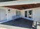 Charming front porch featuring wood ceiling, modern fan, bench, and double glass doors at 4619 Helena Ne St, St Petersburg, FL 33703