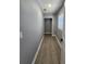 Neutral hallway features wood-look flooring and a door to a closet at 4619 Helena Ne St, St Petersburg, FL 33703