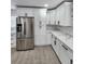 Modern kitchen featuring stainless steel appliances, white cabinets, quartz countertops, and sleek hardware at 4619 Helena Ne St, St Petersburg, FL 33703