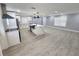 Open kitchen with island, stainless steel appliances, white cabinetry, and pendant lighting at 4619 Helena Ne St, St Petersburg, FL 33703
