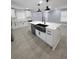 Bright kitchen featuring an island with a sink and stainless steel appliances at 4619 Helena Ne St, St Petersburg, FL 33703
