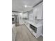 Bright kitchen with stainless steel appliances, white cabinets, and tile backsplash at 4619 Helena Ne St, St Petersburg, FL 33703