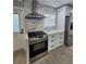 The kitchen has stainless steel appliances, white cabinets, and a tiled backsplash at 4619 Helena Ne St, St Petersburg, FL 33703