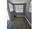 Bright laundry room with wood-look floors, gray walls, and a window offering natural light at 4619 Helena Ne St, St Petersburg, FL 33703