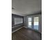 Living room with wood-look floors, and double doors to the patio at 4619 Helena Ne St, St Petersburg, FL 33703