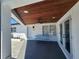 Covered front porch has a ceiling fan and a sitting bench at 4619 Helena Ne St, St Petersburg, FL 33703