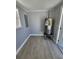 Utility room featuring wood-look floors, gray walls, water heater, and natural light from a window at 4619 Helena Ne St, St Petersburg, FL 33703