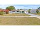 Inviting curb appeal showcasing a freshly landscaped lawn, vibrant bougainvillea, and updated exterior paint at 4727 W Wisconsin Ave, Tampa, FL 33616
