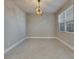 Bright dining room features stylish light fixture and large window letting in plenty of natural light at 4734 Avila Lakes Dr, Wimauma, FL 33598