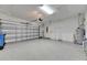 Large two car garage with epoxy flooring and garage door opener system at 4734 Avila Lakes Dr, Wimauma, FL 33598