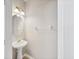 Bright powder room featuring a pedestal sink, oval mirror, and neutral wall color at 4920 Pond Ridge Dr, Riverview, FL 33578