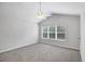 This bedroom features a vaulted ceiling and a view of the outdoors at 4920 Pond Ridge Dr, Riverview, FL 33578