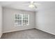 This bedroom features a window, carpet, and ceiling fan at 4920 Pond Ridge Dr, Riverview, FL 33578