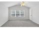 Bedroom with gray carpet, ceiling fan, and natural light from large window at 4920 Pond Ridge Dr, Riverview, FL 33578