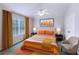 Stylishly staged bedroom with colorful bedding, window, and overhead fan at 4920 Pond Ridge Dr, Riverview, FL 33578