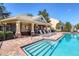 Community pool featuring a safety fence, shaded seating, and a clubhouse in the background at 4920 Pond Ridge Dr, Riverview, FL 33578