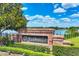 Community entrance sign with beautiful landscaping and scenic lake view at 4920 Pond Ridge Dr, Riverview, FL 33578