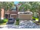 Inviting two-story home with well-maintained front lawn, two-car garage, and mature trees at 4920 Pond Ridge Dr, Riverview, FL 33578