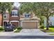 Two-story townhome with a two-car garage and a car parked in the driveway at 4920 Pond Ridge Dr, Riverview, FL 33578