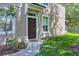 Exterior view of the front door of a townhome with a sidewalk and landscaping at 4920 Pond Ridge Dr, Riverview, FL 33578