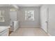 Open hallway with tile floors and neutral paint scheme, with view into adjacent rooms at 4920 Pond Ridge Dr, Riverview, FL 33578