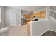 Kitchen features wood cabinets, stainless steel refrigerator, and a view to the stairs at 4920 Pond Ridge Dr, Riverview, FL 33578