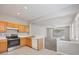 Open-concept kitchen and living area with oak cabinets and stainless steel appliances at 4920 Pond Ridge Dr, Riverview, FL 33578