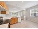 View of kitchen and living space featuring oak cabinets, stainless steel appliances, and tile flooring at 4920 Pond Ridge Dr, Riverview, FL 33578