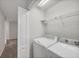 Functional laundry room with modern washer and dryer, and a convenient overhead shelf at 4920 Pond Ridge Dr, Riverview, FL 33578