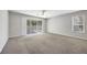 Spacious living room with sliding glass doors leading to the screened patio at 4920 Pond Ridge Dr, Riverview, FL 33578