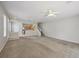 Spacious open-concept living room and kitchen with modern fixtures, carpet, and stair access at 4920 Pond Ridge Dr, Riverview, FL 33578