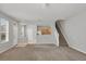 Open-concept living room with light-colored walls, carpeted floor, and view into the kitchen at 4920 Pond Ridge Dr, Riverview, FL 33578