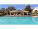 Community pool with lounge seating and shade structure for residents at 4920 Pond Ridge Dr, Riverview, FL 33578