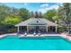 Community pool with a covered cabana, lounge chairs, and well-kept surroundings at 4920 Pond Ridge Dr, Riverview, FL 33578