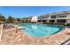 Community pool featuring lounge chairs, brick pavers, and well-maintained landscaping at 4920 Pond Ridge Dr, Riverview, FL 33578