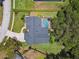 Aerial view of property showcasing backyard pool, mature landscaping, and driveway at 506 Crystal Grove Blvd, Lutz, FL 33548