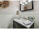 This bathroom features wainscotting and a white marble countertop at 506 Crystal Grove Blvd, Lutz, FL 33548