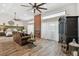 Open concept bedroom with a fireplace, wood-look floors, comfortable leather seating, and lots of natural light at 506 Crystal Grove Blvd, Lutz, FL 33548