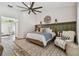 Cozy bedroom features wood-look floors, neutral paint, a large bed, and modern decor at 506 Crystal Grove Blvd, Lutz, FL 33548
