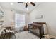 Bedroom with neutral decor, wood floors, and a crib, offering a peaceful retreat at 506 Crystal Grove Blvd, Lutz, FL 33548