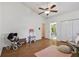 Bright bedroom featuring wood floors, a ceiling fan, and plenty of space at 506 Crystal Grove Blvd, Lutz, FL 33548