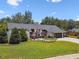 Inviting house with lush green lawn, mature trees, and a two-car garage at 506 Crystal Grove Blvd, Lutz, FL 33548