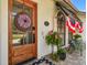Close up of the front door featuring a charming wreath and patriotic decorations at 506 Crystal Grove Blvd, Lutz, FL 33548