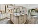 Gourmet kitchen featuring a spacious island with granite countertops, custom cabinetry, and modern appliances at 506 Crystal Grove Blvd, Lutz, FL 33548