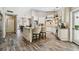 Bright kitchen features custom white cabinetry, stone countertops, and wood-look tile flooring at 506 Crystal Grove Blvd, Lutz, FL 33548